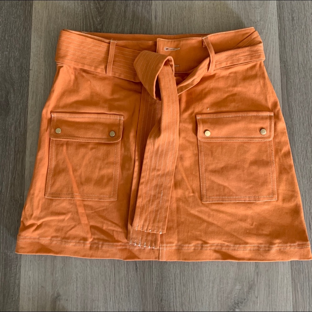 Neon orange skirt w tie are matching jacket